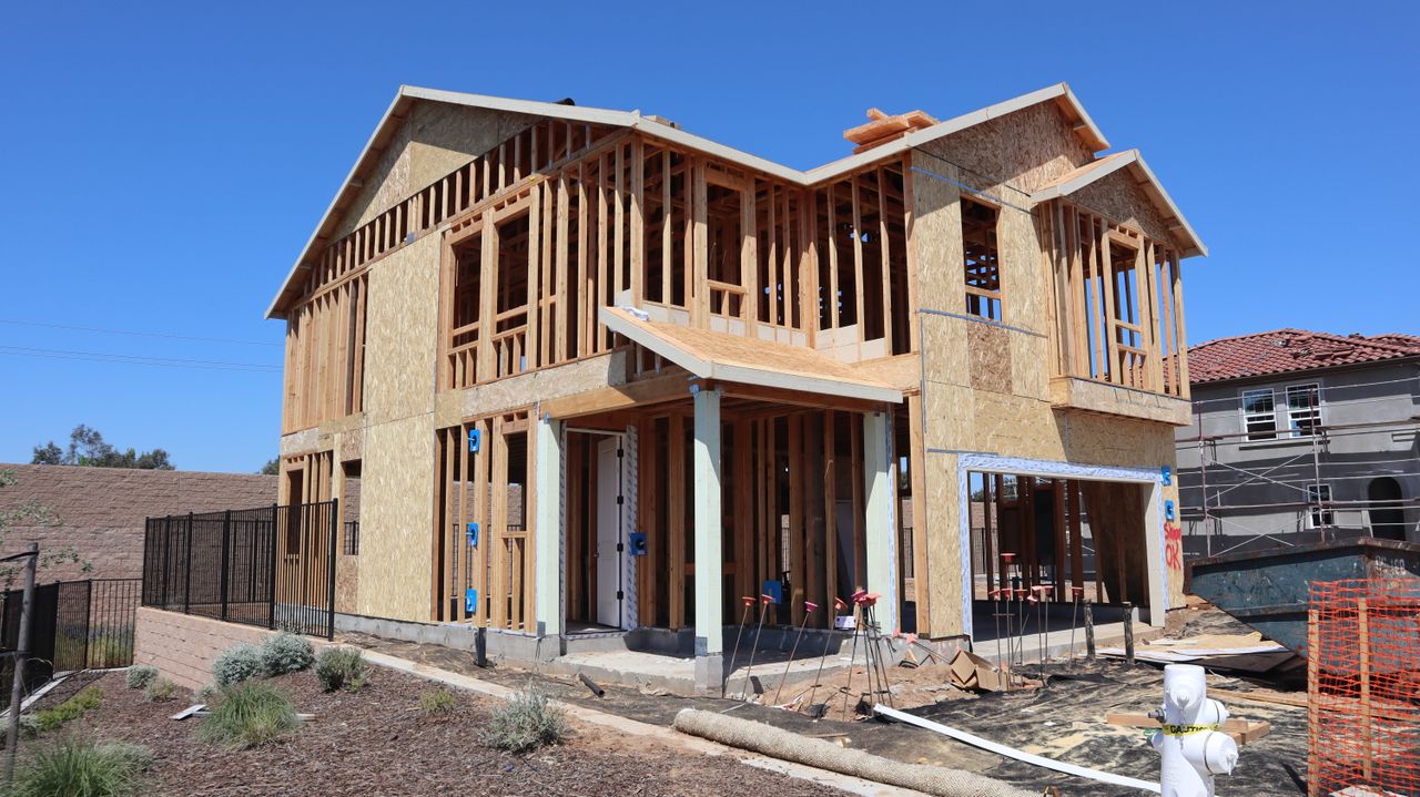 Mastering the First Impression: Your intriguing post title goes here New suburban house in Elk Grove, California under construction, showing framing and development.